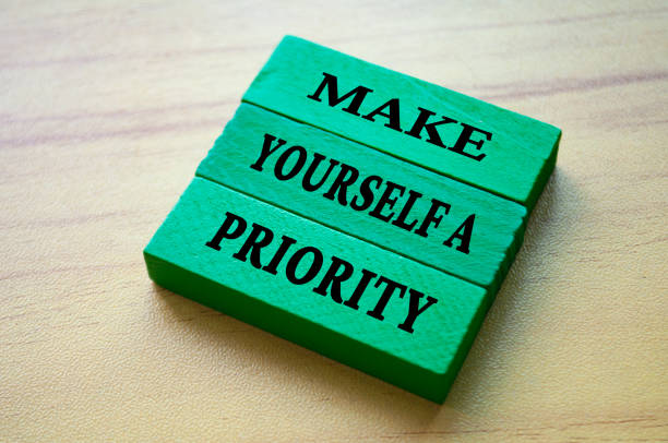 Make yourself a priority text on green color wooden blocks. Aspiration quote