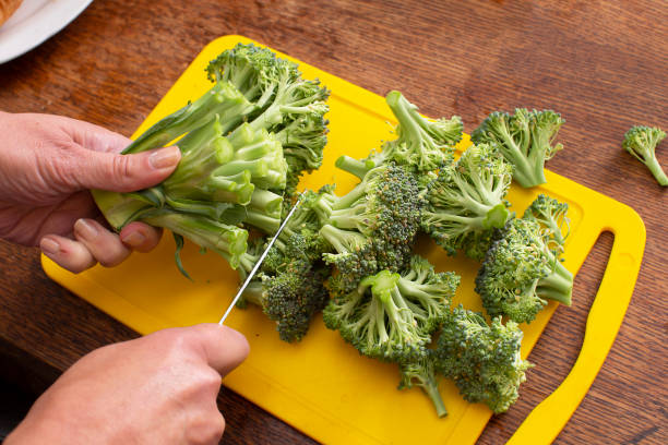istock Hands cutting broccoli cabbage. Healthy green vegetables. 1942354781