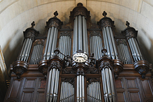 Aarhus Domkirke, Aarhus, Denmark, October 21, 2020:  Old organ in a church. The construction of the cathedral of Aarhus, called St. Clemens began in 1190 and despite the switch to Protestantism some of the original frescos is still visible in the church.