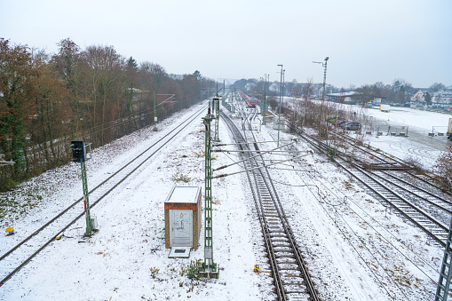 Kirchheim Teck, Germany, January 17 2024: Railway line Kirchheim to Stuttgart covered in snow with S-Bahn