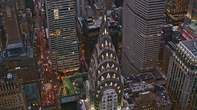 AERIAL Above the Chrysler Building in Midtown Manhattan, NYC in the evening