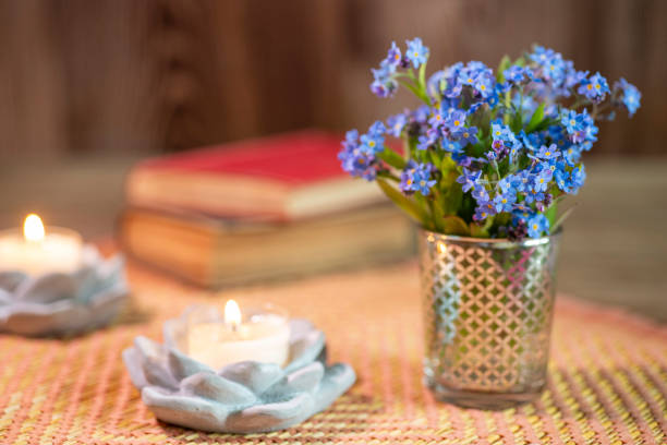 Forget-me-not Bouquet with candle on wooden table