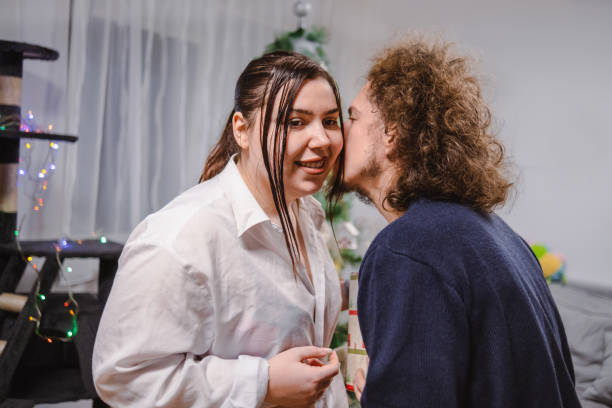 Young adults kissing at a house party in latin america