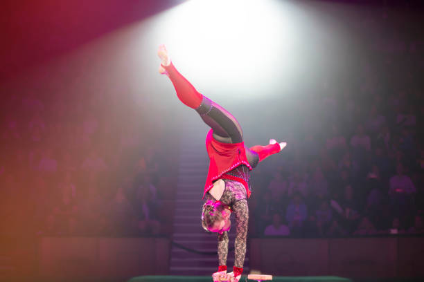 istock A gymnast performs in a show. A girl gymnast performs a circus acrobatic performance. 1942400579