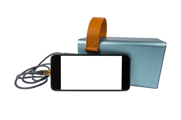 A smartphone with a blank white screen is being charged from a large power bank (charging station) via a USB cable, isolated on a white background. Mobile power supply