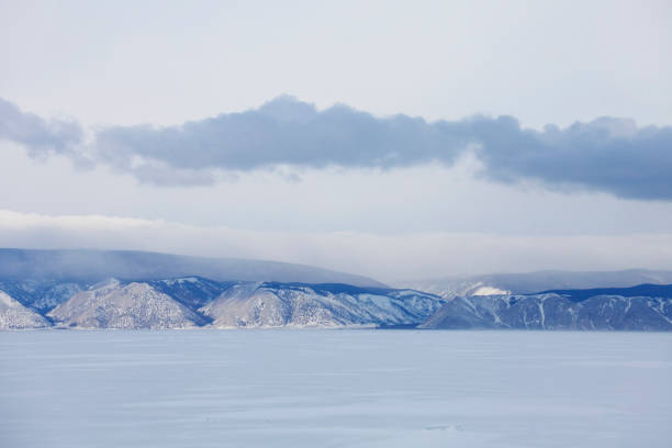 Winter landscape. Baikal lake. Snowy mountain peaks