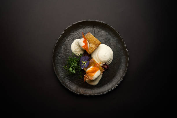istock Puff pastry croissant with ice cream on a black plate. 1942441273
