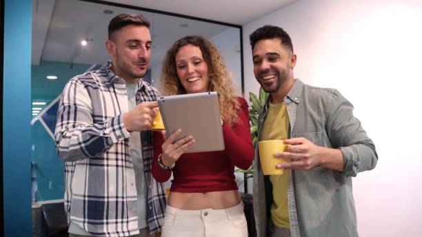 istock three young coworkers laughing and enjoying work 1942441818