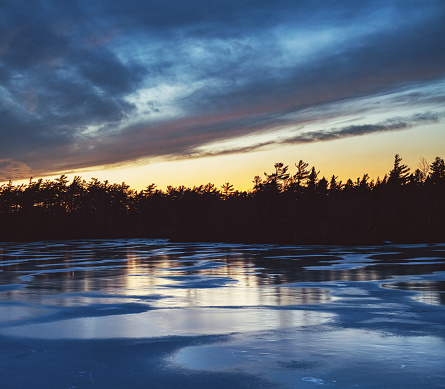 Twilight on a frozen lake in January.