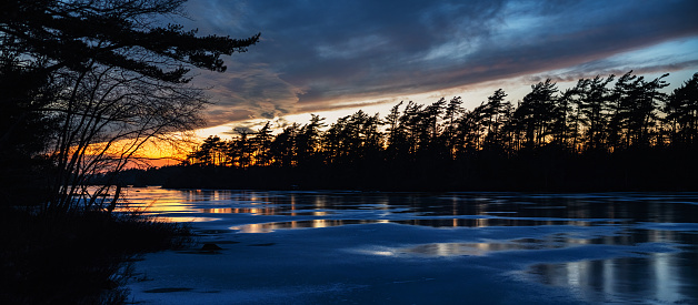 Twilight on a frozen lake in January.