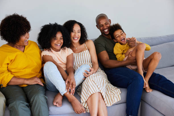 istock Multi-generation family laughing while watching tv at home 1942457499