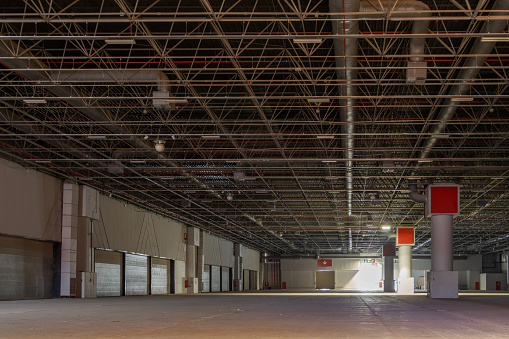 Empty and dark large warehouse. factory warehouse, interior view storage and logistics