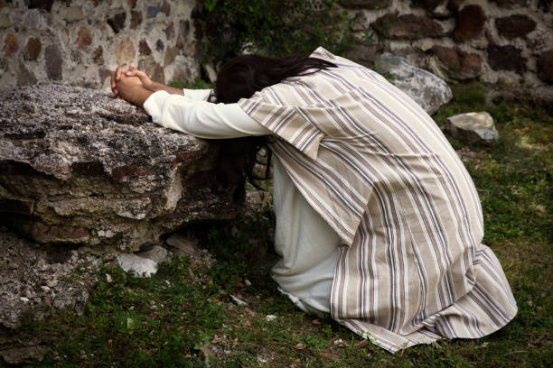 Jesus praying in the garden of olives Jesus in agony praying in the garden of olives before his crucifixion garden of gethsemane stock pictures, royalty-free photos & images