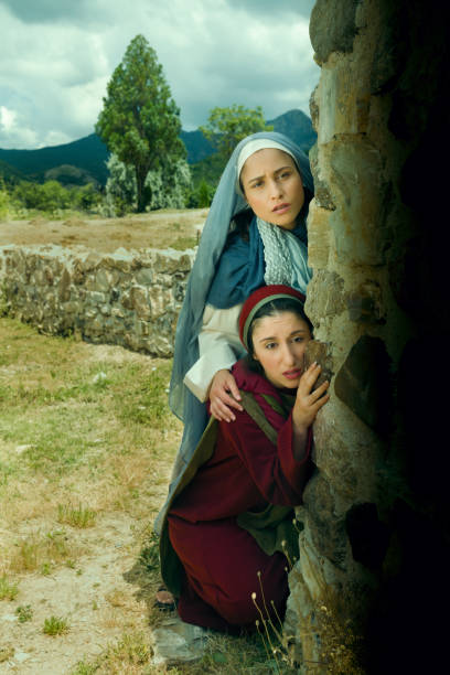 Woman at Jesus grave at Easter Scared Mother Mary and Mary Magdalene standing at the entrance of the empty tomb of Jesus on Easter morning tomb of the virgin mary in jerusalem stock pictures, royalty-free photos & images