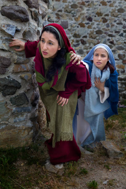 Women discovering Jesus resurrection Mother Mary and Mary Magdalene standing at the entrance of the empty tomb of Jesus on Easter morning tomb of the virgin mary in jerusalem stock pictures, royalty-free photos & images