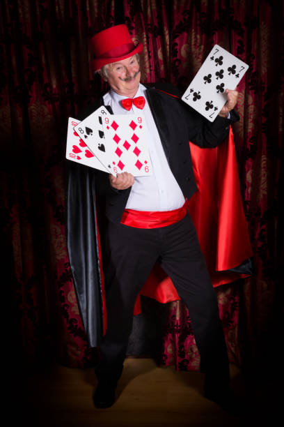 istock Happy magician with cards 1942480947