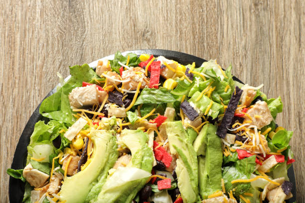 istock Chicken avocado salad dish on wooden table 1942488986