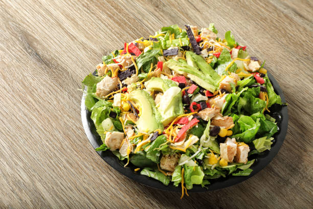istock Chicken avocado salad dish on wooden table 1942489521