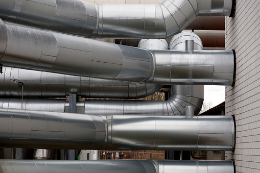 Pipes, tanks, water valves and other outdoor installations of a residential district heating plant.