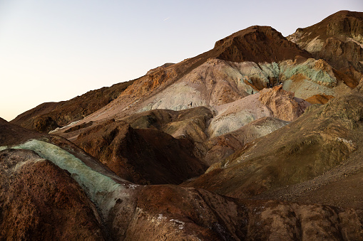 Artist Palette's radiance after sunset: The vibrant hues of desert colorful hills linger, creating a mesmerizing display of colors on the artist's canvas long after sunset