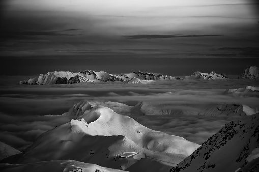 Two moto paragliders in the beautiful mountain in the winter black and white