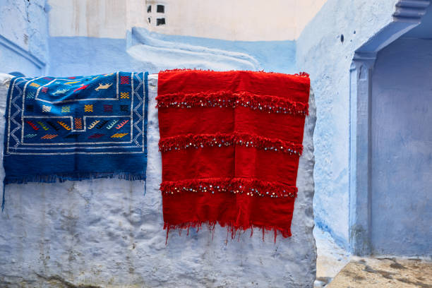 istock Blue wall with colourful Moroccan rugs in Chefchaouen, Morocco 1942508882