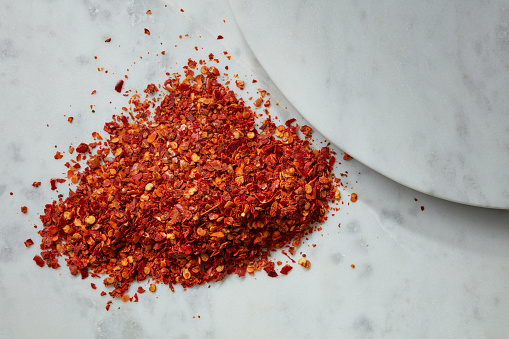 Dry grated red pepper. Flat lay