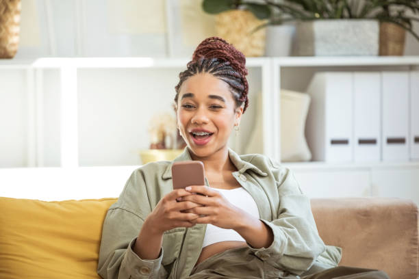 istock Happy young women using smart phone at home 1942515711