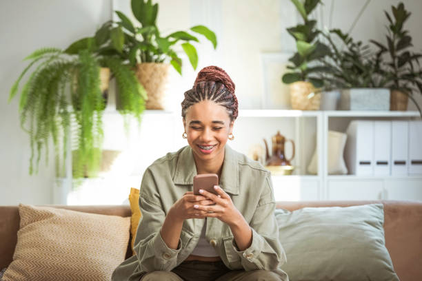 istock Happy young women using smart phone at home 1942516733