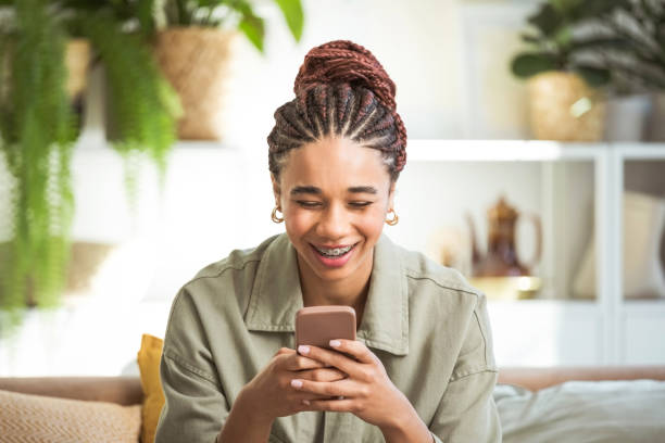 istock Happy young women using smart phone at home 1942517267