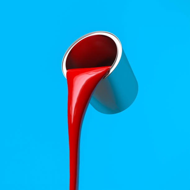 istock red paint poured from a metal can, blue background. 1942518844