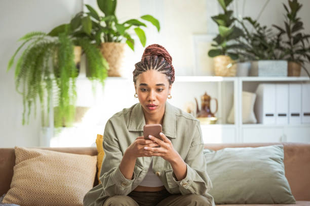 Worried young women using smart phone at home