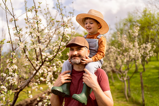 Father and son enjoying a carefree spring day in the country side.