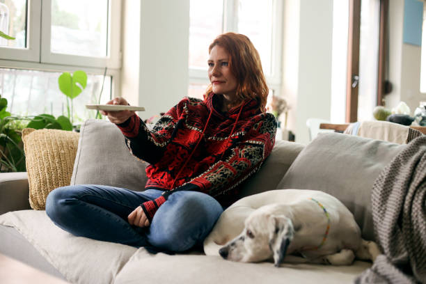 istock Woman watching TV with her dog 1942523633