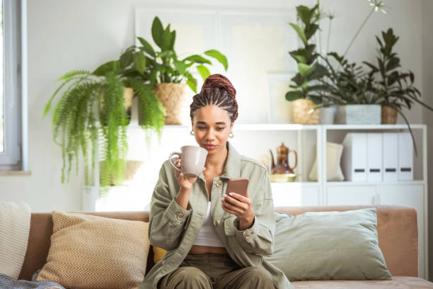 istock Young women using smart phone at home 1942524321
