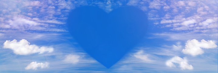 Fluffy clouds forming a heart shape on sunset sky background, soft focus. Heavenly clouds. Holidays of love, Valentine, Mother day, romantic.  Copy space. Empty place for message.