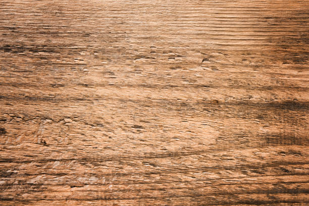 Empty rustic wooden table background. Old wood table with dark blurred background. Mock up.