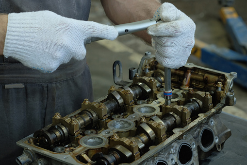 Part of car engine, four valve in head for each cylinder, selective focus