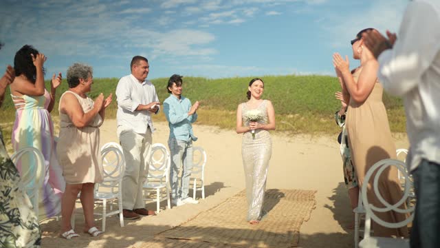 Bride entering wedding on the beach