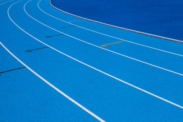 istock Blue Olympic track lanes with white stripes, an empty background suitable for copy space, represent the concept of physical sports and running, symbolizing commitment and pathways towards goals 1942594097