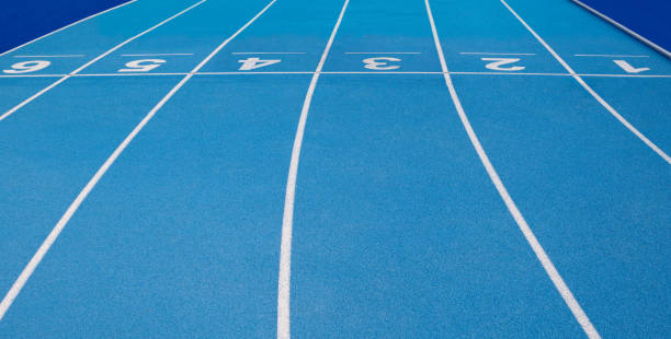 Olympic track lanes with white stripes and start and finish numbers, empty Blue background for copy space, concept of physical sports and running, symbolizing commitment and paths to goals