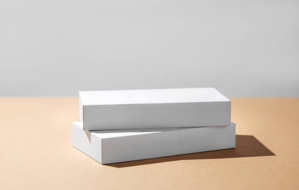 istock Empty podium for product. Minimal two white boxes on a beige background with hard shadow. 1942607932