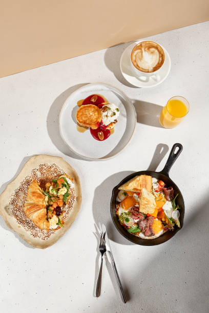 istock Gourmet Breakfast Spread with Croissant, Skillet Eggs, and Pancakes. Top view. 1942614892