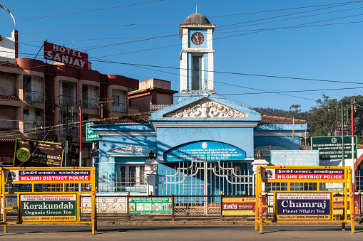 Ooty, Tamil Nadu, India - October 8 2023: An old vintage clock tower in the Charring Cross market area in the hill station town of Ooty.