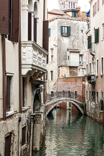 A narrow canal bridge in the city of Venice, Italy.