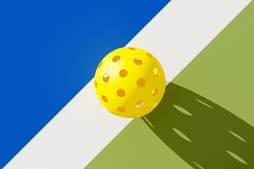 Top view of pickleball ball on court. 3d illustration, render.