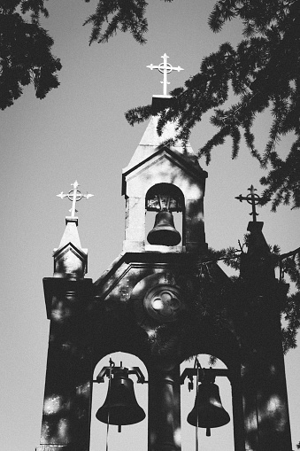 The church with three bells on the bell tower is black and white