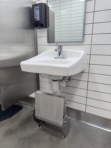 Public restroom sink with kid step stool