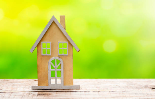 istock Wooden house model on wooden table 1942665702