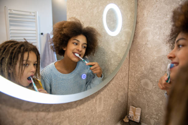 istock Brother and sister brushing teeth 1942671511